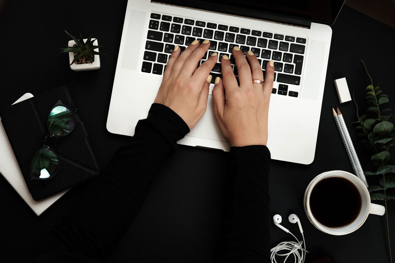 workspace-with-womans-hands-laptop-plant-coffee-cu-Q3R6V7Ca